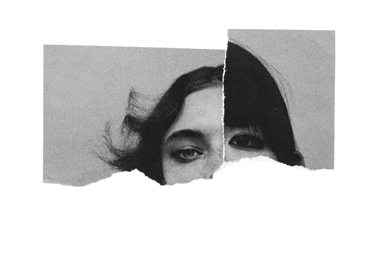 Creative collage of torn paper showing a woman's eyes in monochrome.